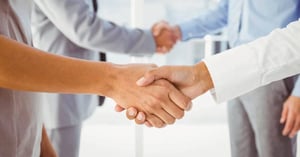 Two fellow employees shaking hands at work-03-1